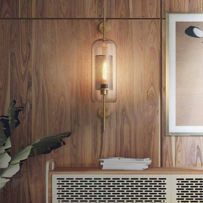 Decorative wall sconce with glass shade on a wooden wall.