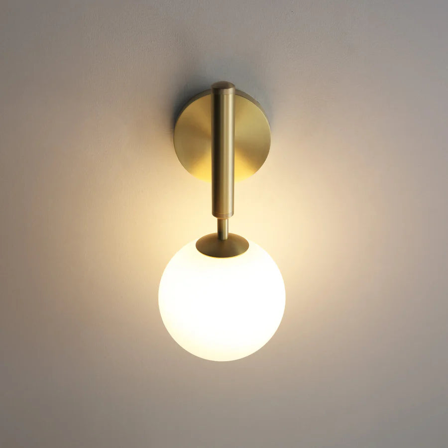 Wall-mounted GLOW CRYSTAL BALL LED WALL SCONCE LIGHT with gold finish and white bulb on a neutral background