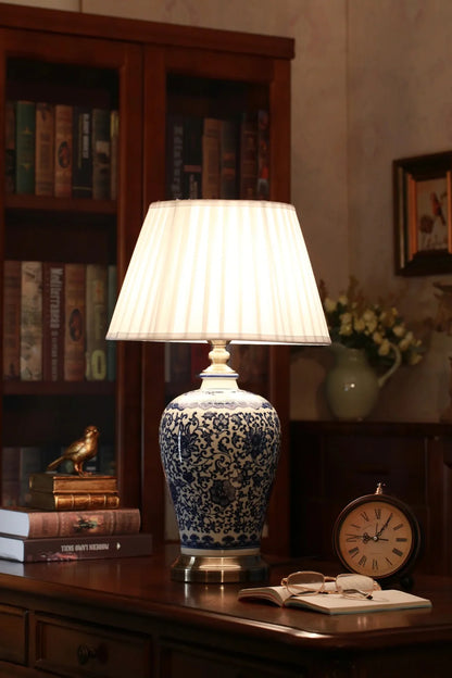 GLOW KANAGAWA WAVE TABLE LAMP with blue floral patterns on a wooden desk.