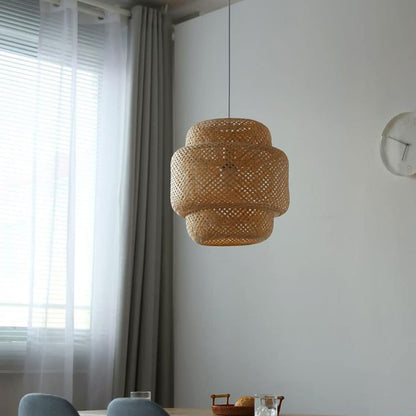 GLOW VENUS FIGURINE RATTAN PENDANT LIGHT hanging in a room with a window and clock on the wall.